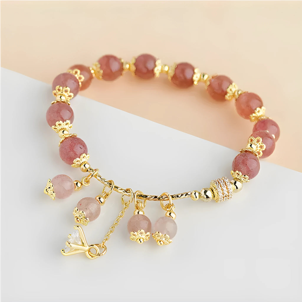 Pink women's crystal bracelet with heart-shaped charms and pearl decorative accents
