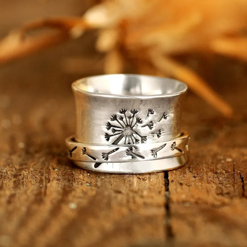 Silver rotatable flower ring showing spinning petals on alloy band