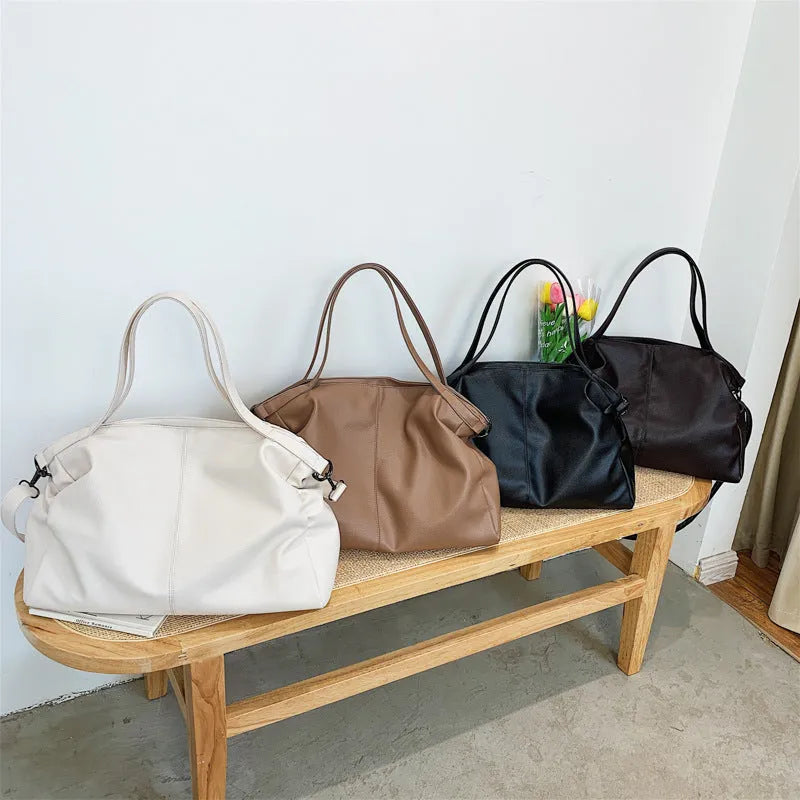 Large soft-surface PU leather messenger tote bag with long crossbody strap, shown in black colour