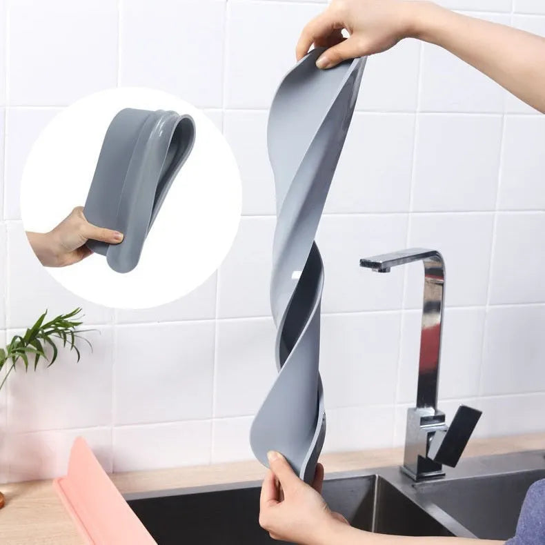 Grey silicone sink splash guard measuring 85 cm long, placed on a kitchen worktop.