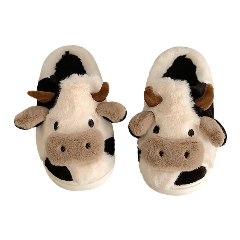 White and coffee coloured cow-themed plush slippers for women with a textured non-slip sole.