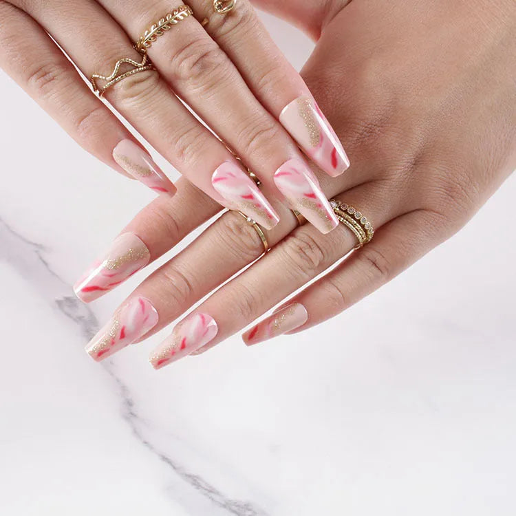 Wearable manicure set with 24 medium nails in rose, tulip, leopard print, and XINGX designs, plus glue.