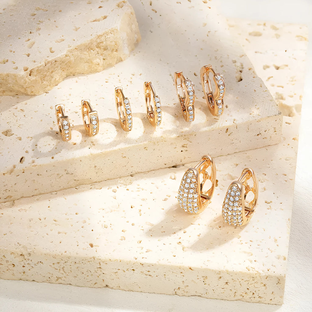 Gold-plated brass heart-shaped clip earrings with zircon stones and gang drill detailing