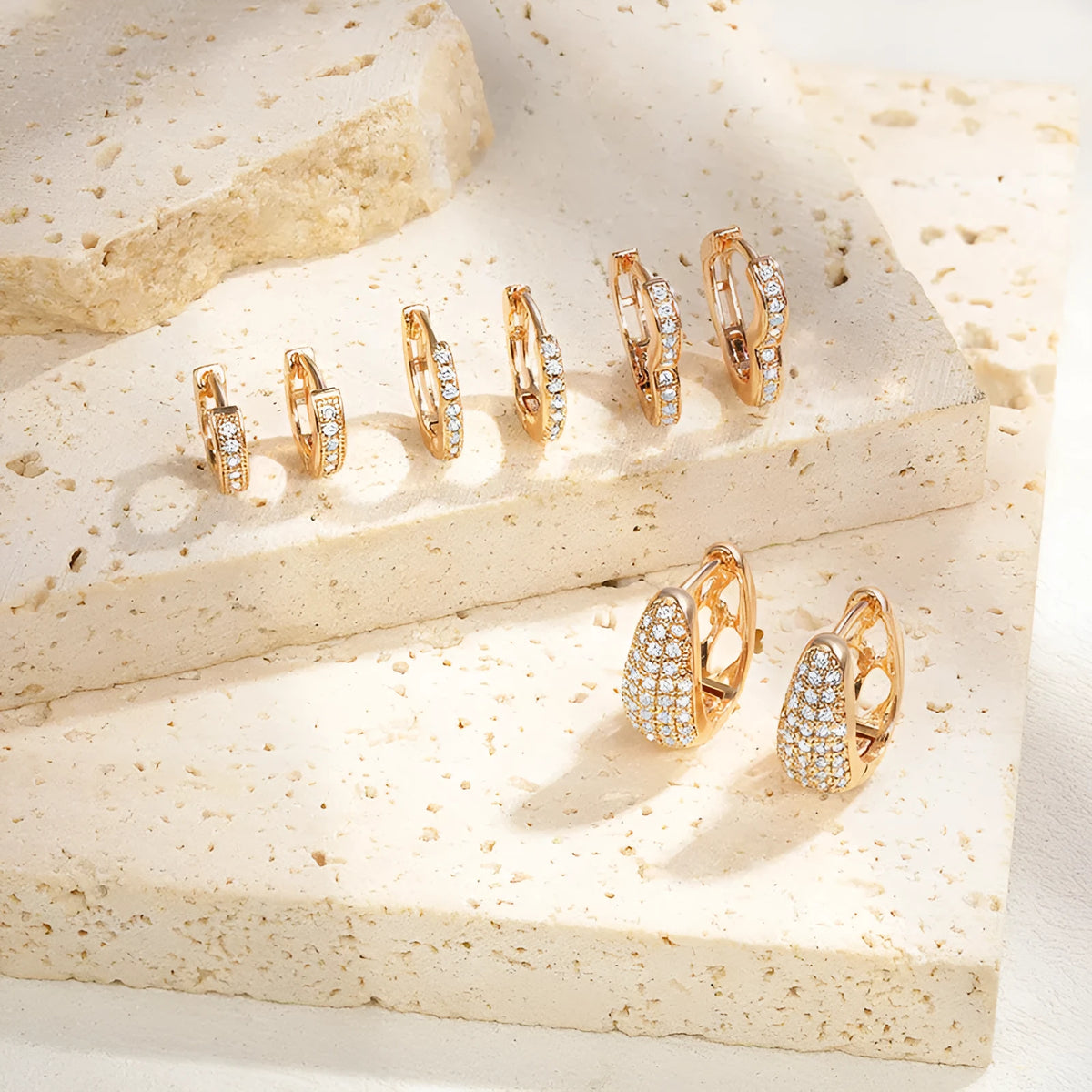 Gold-plated brass heart-shaped clip earrings with zircon stones and gang drill detailing