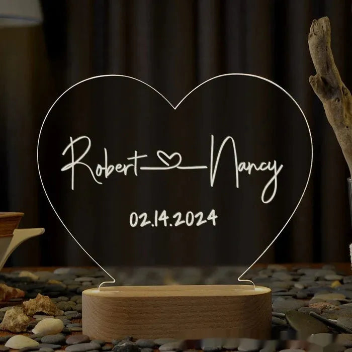 Custom couple names and date engraved on a transparent acrylic LED night light.