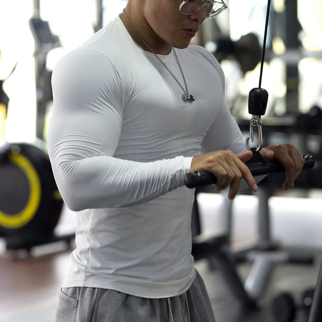 Men's black fitness tights with long sleeves and slim fit design for exercise