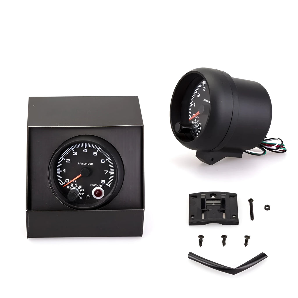 Black automotive tachometer with blue light pointer display and digital readout showing RPM measurement