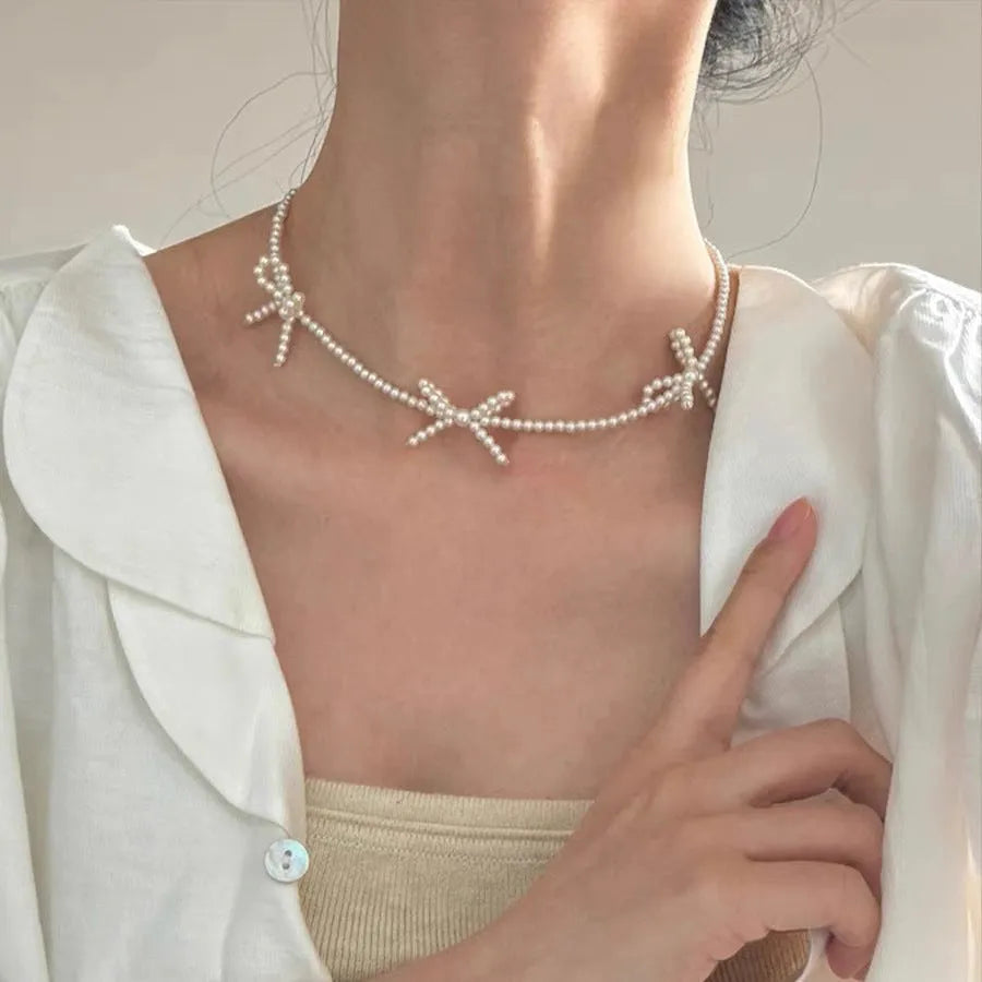 White geometric bow pearl necklace for women with adjustable 31-40cm length