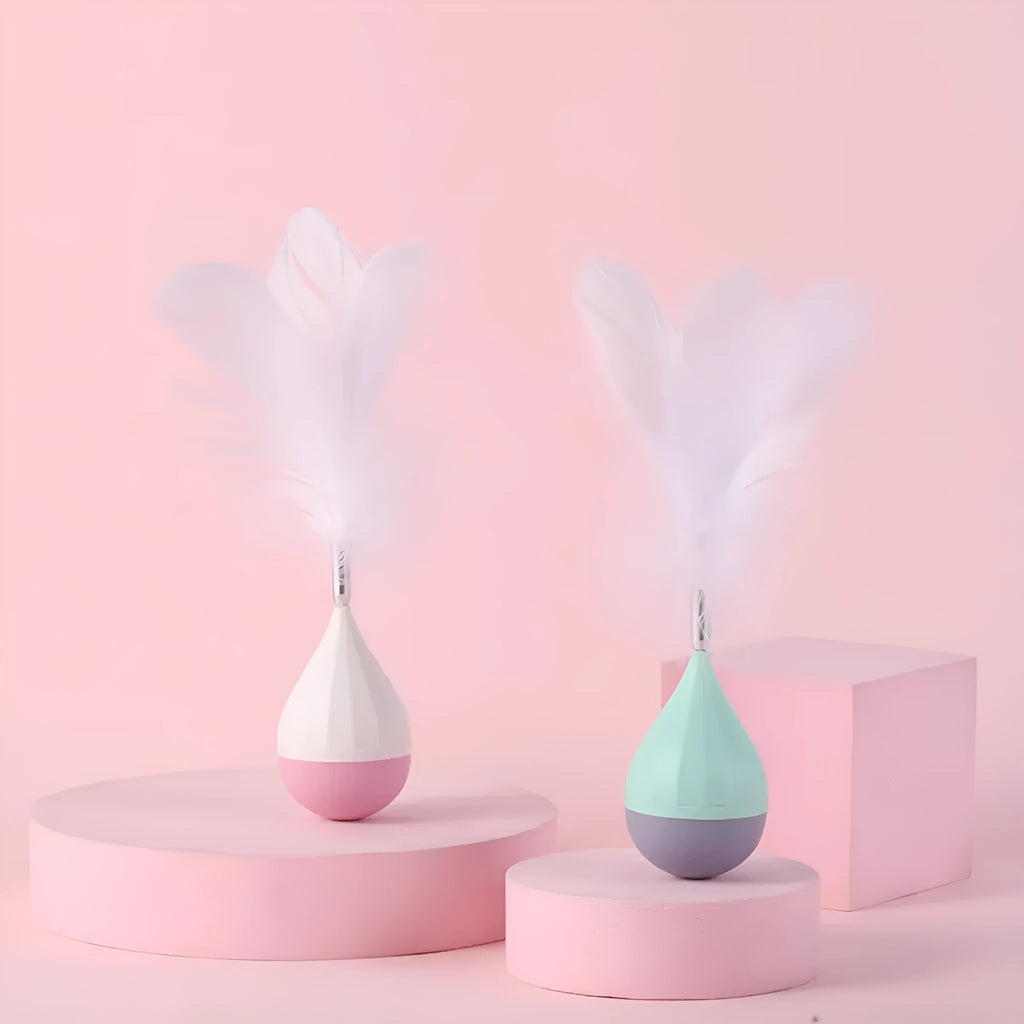 Green and pink feather tumbler cat toy with self-healing design