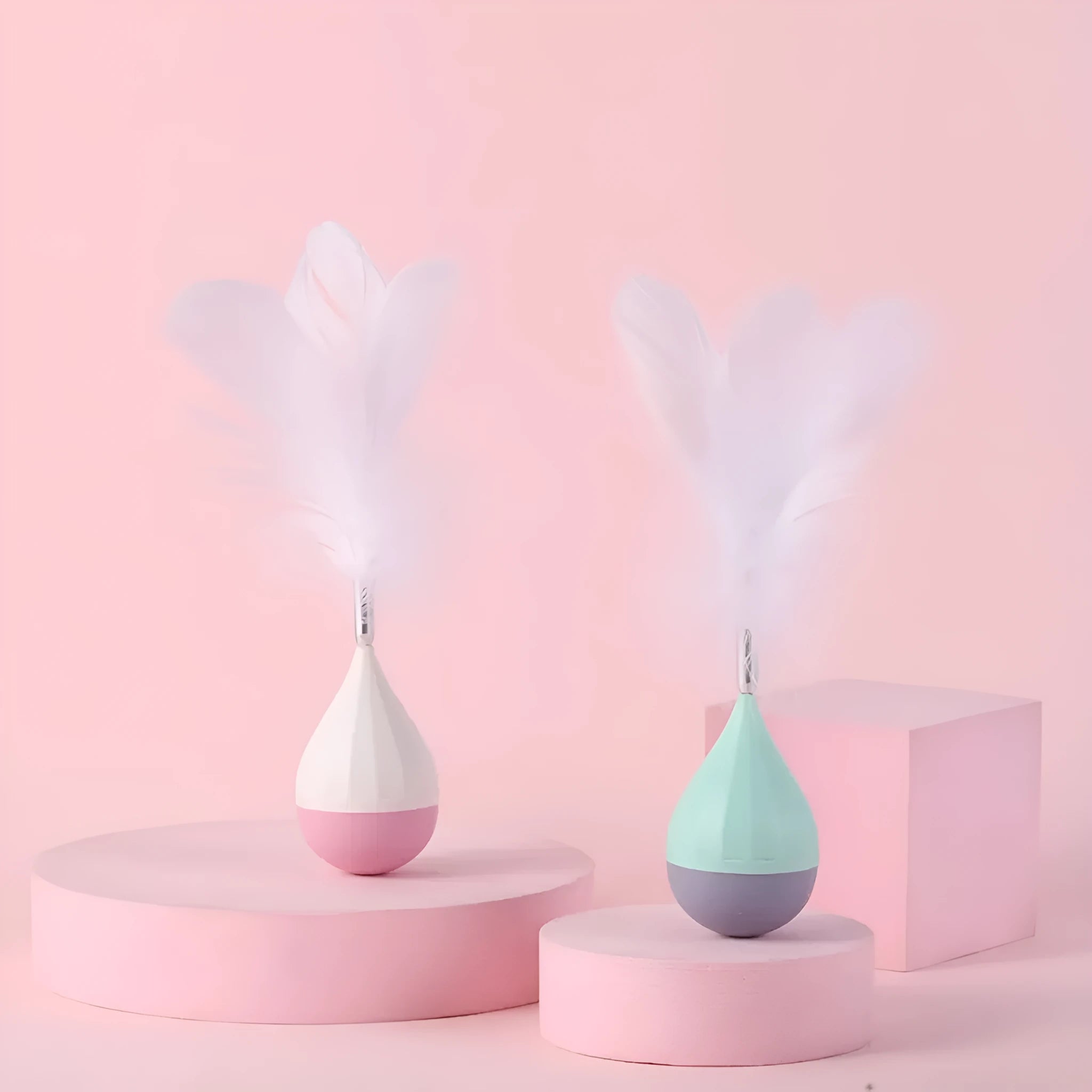 Green and pink feather tumbler cat toy with self-healing design