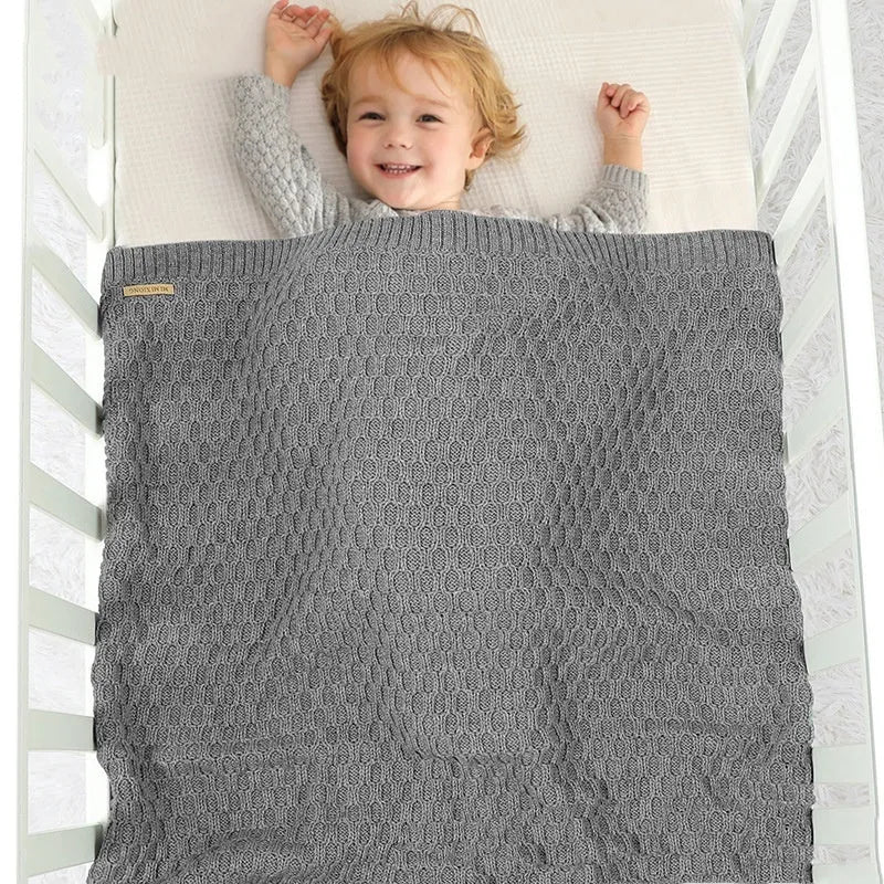Solid colour acrylic infant blanket with textured lines measuring 70×90cm in pink, beige, grey, or green