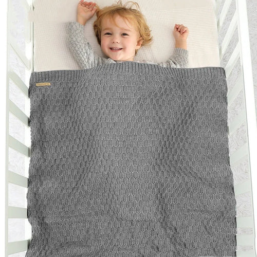 Solid colour acrylic infant blanket with textured lines measuring 70×90cm in pink, beige, grey, or green