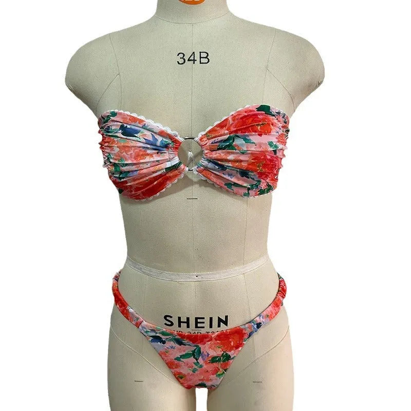Women's floral print polyester bikini set in blue on a mannequin, showing tube top and briefs.