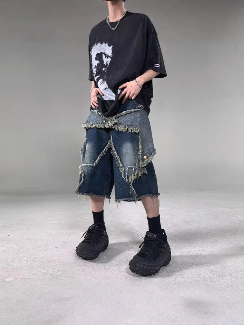 Men's blue retro denim shorts with a frayed five-pointed star design on the leg, showing loose fit.