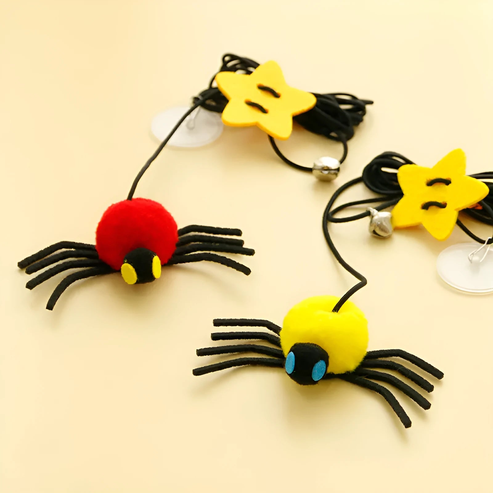 Red and yellow cat hanging door toy with elastic rope, feather, bell, and spider attachment