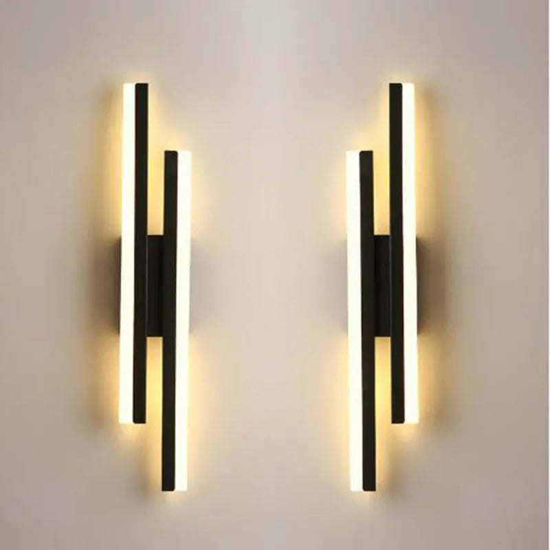 Scandinavian minimalist LED wall light with an acrylic shade on a black arm, mounted on a light-coloured wall.