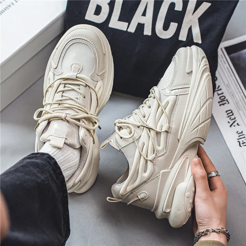 Men's low-top sneaker in beige with mesh PU leather upper and lace-up design on a rubber sole.